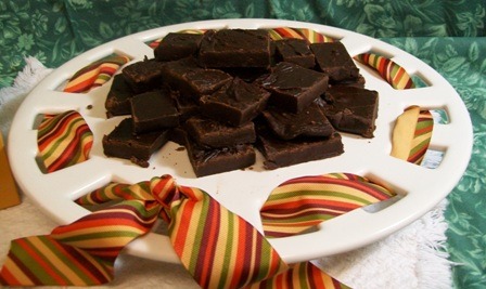 Rich chocolate fudge squares arranged on a decorative platter
